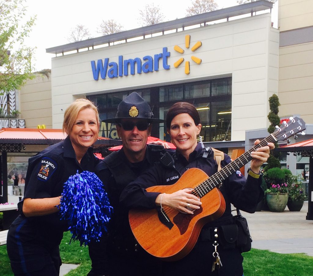 Photo of three police officers playing guitar and smiling to the camera