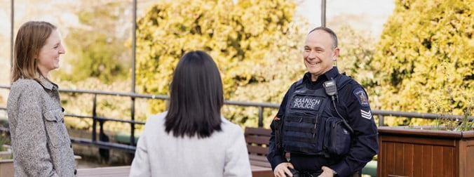 Photo of a police officer speaking with two individuals